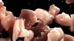 clip-1111785425-pieces-raw-chicken-fly-fall-down-filmed