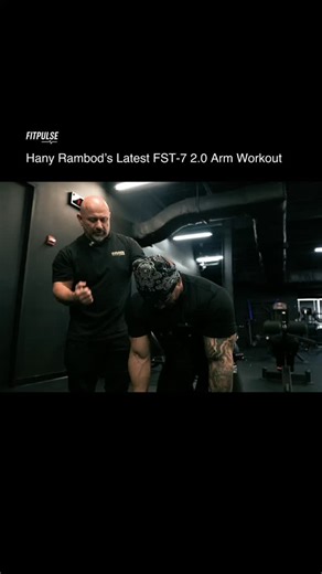 Workouts | Form Fixes | Muscle Growth on Instagram: "In this session, Hany Rambod puts Jeremy through a structured 6-exercise arm day built around control, stretch, and constant tension. The workout is split cleanly: 3 movements for biceps first, then 3 for triceps to finish. The goal isn’t random volume — it’s strategic fatigue and fascia expansion, which is what FST-7 is known for. For biceps, they start with Spider Dumbbell Curls to eliminate momentum and isolate peak contraction. Then come C