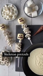 Easy Halloween skeletons! Marshmallows dipped in white candy coating with some store-bought white fudge pretzels (like @flipz). The sticks are extra long lollipop sticks, and I piped on a little skeleton face after the marshmallows had set up. #halloweentreats #halloweenparty #halloweencandy #funfood #marshmallows | One Sweet Mama