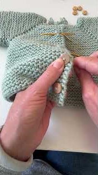 How to sew buttons on a cardigan.