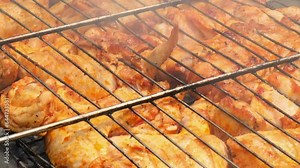 BBQ picnic time Roasted chicken legs and wings on grill. Grilling meat on outdoor grill grid tasty barbeque chicken steak with smoke flames juicy meat in the backyard in summer