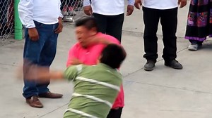Men, women and children engaged in brutal street fighting in the village of Zitlala in southern Guerrero state, Mexico, on Tuesday to commemorate centuries old battles with the Aztecs. Fuelled by booze and music, members of the Nahua Indian community traded blows in fierce clashes that only end when fighters quit or are knocked out. The festival emerged more than 500 years ago when Aztecs who would come to Nahua communities to steal women. Back then men would wear skirts to try to fool the invad