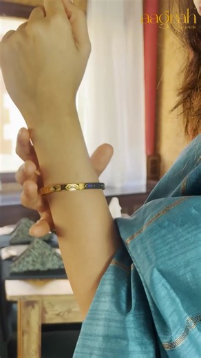 Aagrah Fine Jewels™ on Instagram: "Some style does double duty. It elevates your look, while protecting your energy. The Glimmering Gaze Bangle was made for this feeling: 🧿 A mesmerizing evil eye motif to ward off negativity. 💎 Meticulously paved with sparkling AD Zircon stones. ✨ Intricate cut-out detailing on a rich gold-plated band. 🔒 Secure side-clasp & anti-tarnish finish for daily wear. 🎁 Includes free gift box & frosted pouch. It’s more than just a bangle — It’s a radiant talisman for