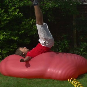 In this iconic #slowmo, Gavin and Dan try multiple times to burst a 6ft giant red balloon filled with water. | The Slow Mo Guys