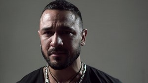 Crying man with tears on face closeup. Tears in eyes of crying adult man