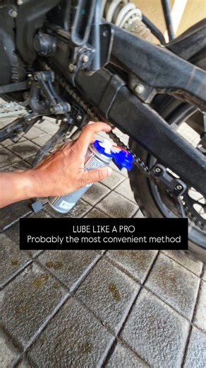 This is the easiest way I have found to clean & lube a motorcycle chain. My chain cleaning setup: I completely soak the chain with a chain cleaner, and my go-to product for the last 5 years has been Maxima Chain Cleaner. It needs very little effort: spray it on, scrub only where the muck is stubborn, and then rinse it off with water. The grime and old lube usually wash off as a whitish-grey slurry, leaving the chain fresh and ready for lube. Trials with other methods: Over the years, there have 