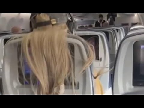 Furious plane passenger puts gum and coffee in woman's hair after she blocked her tv