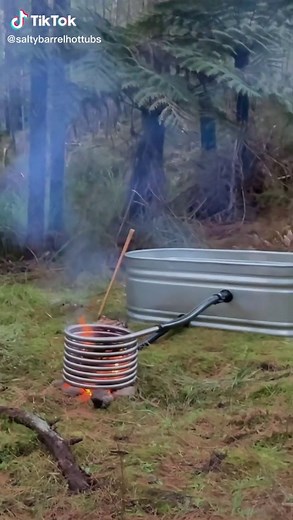 Wood fired stock tank hot tub in the forest | tub
