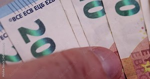 Cash ten euro banknote close-up , details of the 10 euro banknote of the European Union moved by hands