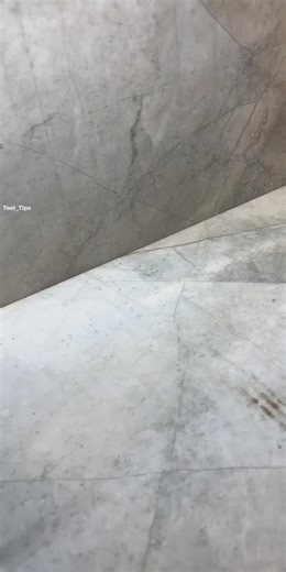 Applying Red Adhesive Sealant on Tiled Floor