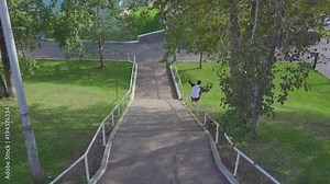 Aggressive inline roller blader grind on rail in skatepark outside. Clip. Summer extreme sport exercising outdoor in skate park. Various tricks