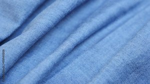 Blue fabric of high quality denim details and texture tilting 4K 2160p 30fps UltraHD video - Dugaree jeans cloth in blue color gathers close-up slow tilt 4K 3840X2160 UHD footage