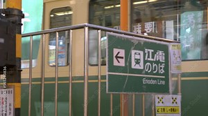 Enoden line, focusing on the guardrail, and the train passes by