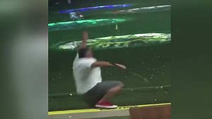 Going, going, gone! Man takes a swing and falls off platform at Top Golf
