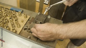 Jeweller creating a gold ring with a Bending machine