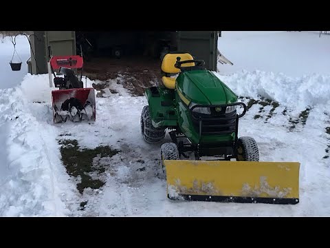 John Deere X330 plowing snow