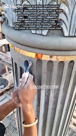 carving decorative grooves into a large concrete column.