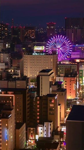 Watching the city transition from dusk to night in Sapporo, Japan. 🎡🇯🇵