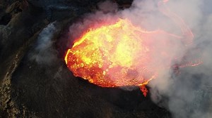Aerial view over volcanic eruption, Night view, Mount Fagradalsfjall 4K drone shot of lava spill out of the crater Mount Fagradalsfjall, September 2021, Iceland