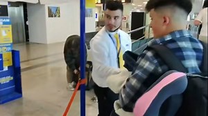 Boy falls for hilarious oversized boarding pass prank before boarding flight