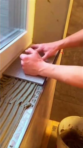 installing ceramic tiles on window walls