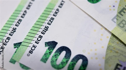 Close-up sequence of euro banknotes showcasing intricate designs, denominations, and security features, highlighting the transition from one note to another in a smooth visual flow