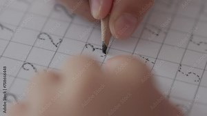 School Boy Practicing Writing Numbers at Home. Child Working on His Homework. Little Boy Studying Learning at Home. Child, Learning Doing Math for Education, Making Homework Numbers in His Room.