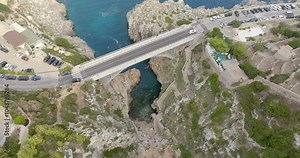 Aerial view of Ciolo's Bridge in the province of Lecce, Salento, Puglia, Italy. It is a single-span bridge and crosses a inlet. It overlooks the Mediterranean Sea.