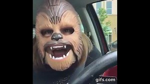 Woman laughs hysterically at herself in Chewbacca mask