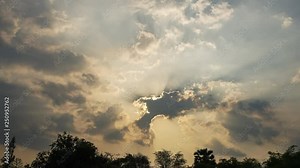 Beautiful cloudscape with large building clouds and sunset breaking through cloud mass timelapse 4k UHD