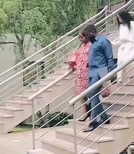 Stylish Woman in Pink Dress Descends Outdoor Stairs
