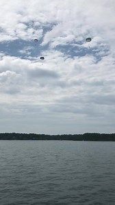 Members of the Airborne and Special Operations Test Directorate jump into Lake Auman in 7 Lakes West. More than 500 residents and more than 50 boats watched. | XVIII Airborne Corps