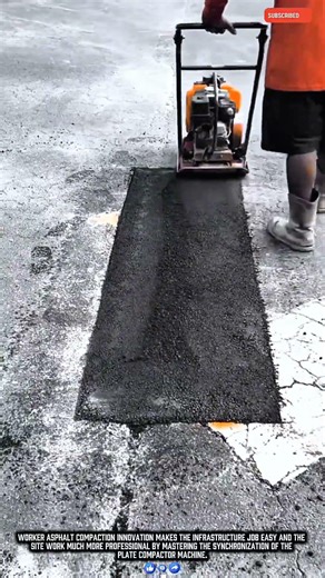 Worker compacting asphalt patches with a plate compactor for smooth production results