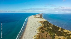 Farewell Spit is a narrow sand peninsula at the northern end of the Golden Bay, South Island New Zealand - pullback aerial hyper lapse