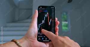 Close up businessman is checking bitcoin price chart on digital exchange on smartphone at office corridor, businessman using smartphone app to predict future stock price action indoors