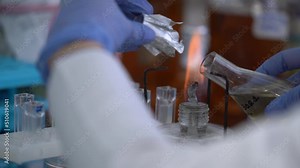 Burner glass in laboratory. Bunsen burner experiments. Laboratory experiment, tube with liquid and burner glass in bio lab. Concept of science in laboratory. Lab fire for science research experiment