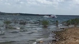 Biplane crashes, flips upside down on a lake caught on camera