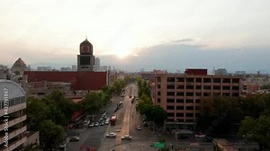 Forward flying drone camera following wide street in low traffic hour. Downtown life at twilight. Mexico city, Mexico.