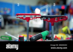 Close up footage of pointless dent repair process on car body, mechanic at the auto shop with tools to repair dents in damaged car body. PDR. High quality 4k footage