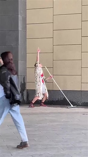 Dancing Sweeper Goes Viral Outside Glass Door