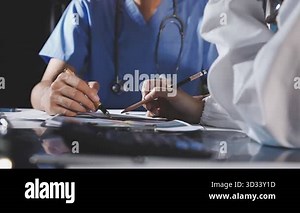 doctor working with tablet computer and medical team in hospital