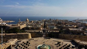 Aerial drone view of Valletta - capital of Malta island Europe, Mediterranean sea main church, dome, view of the Triton Fountain in the city center