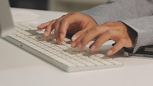 Download A person typing on a keyboard for free