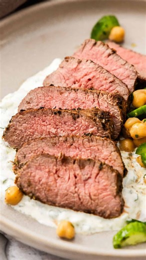 Alexandra Cook | Easy Delicious Recipes on Instagram: "Marinated Lamb Backstrap is a crowd pleaser. ❤️ Comment SEND RECIPE and I’ll send it to you in a message ✨ Lamb backstrap is a small, boneless, premium cut of meat that comes from the back of the lamb. It is lean yet tender, cooks quickly and is full of flavour making it perfect for busy nights or when entertaining. The lamb is infused with traditional Mediterranean flavours and then seared in a frying pan. We serve the succulent Greek style