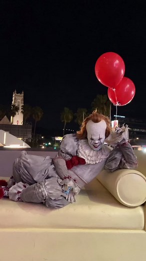 Whimsical Clown Performance in Urban Night Scene