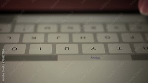 woman typing a text on the virtual keyboard of a tablet computer: touchscreen