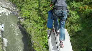 Experience the thrill of jumping off the iconic San Francisco Bridge in Baños,Ecuador,captured in stunning wide angle slow motion footage.