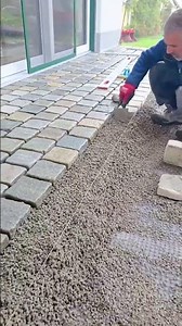 Laying natural stone cobblestones on a terrace base for a durable outdoor pavement