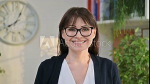 Headshot portrait of mature smiling woman looking at camera