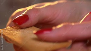 Female hands cracking crisp bread in slow motion closeup